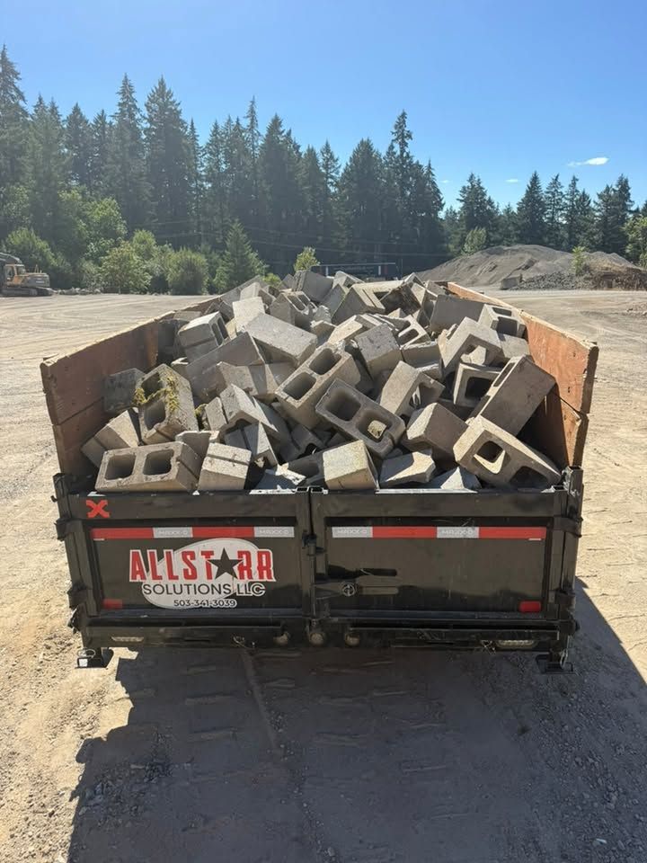AllStarr Solutions dump trailer loaded to the rails with broken concrete blocks