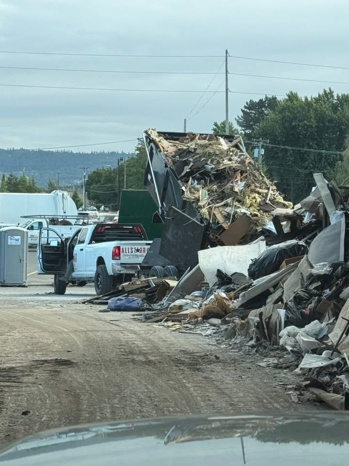Dump trailer tipped up unloading a full load of debris at the transfer station